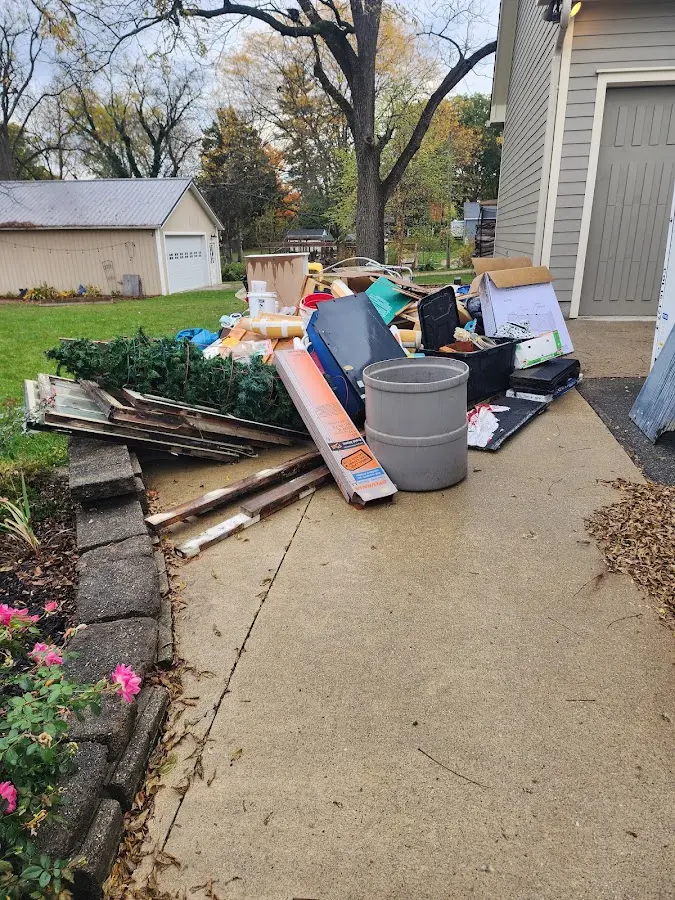 Dumpster being loaded with debris for Estate Cleanout Dumpster Rental in Cheboygan